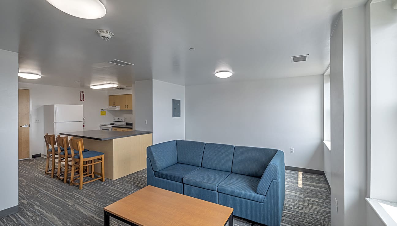 Photo of a large dorm room featuring a large couch