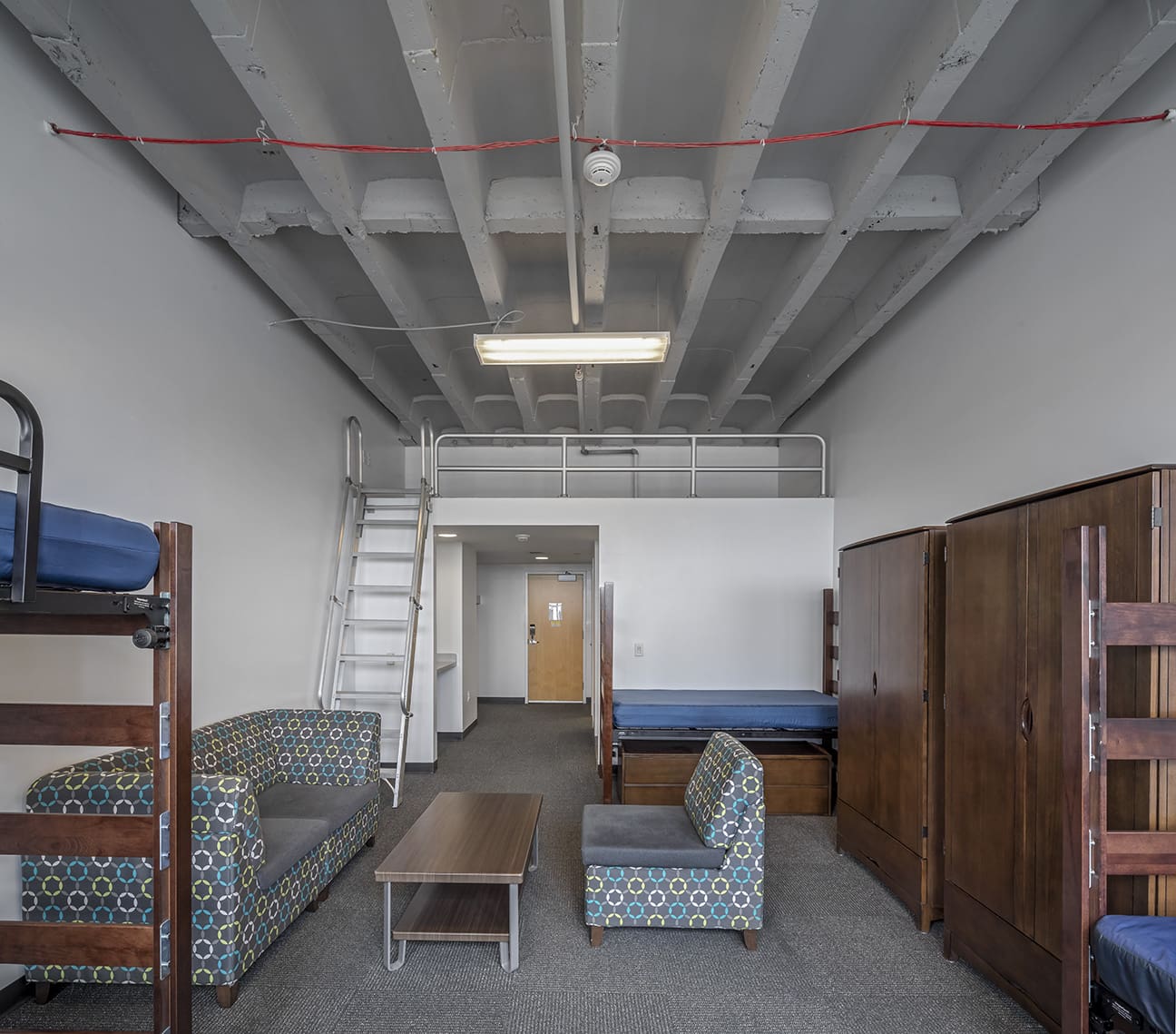 A photograph of a three person dorm room in the Taubman Center student housing.