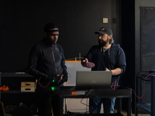David Gazdowicz working with a student on the computer using new motion capture Rokoko suits