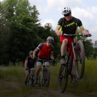 Photos of BMX bikers driving down a grassy nature trail.