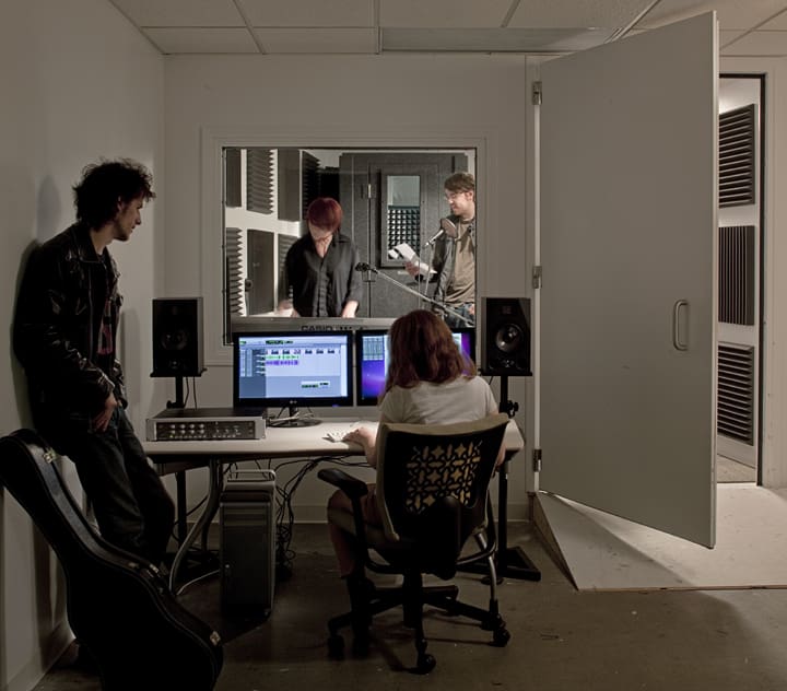 Sound-Contained Room with students working with audio mixing equipment