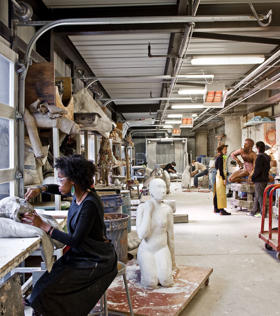 students working in a sculpture studio on campus