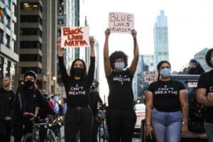 Activists wearing I Can't Breathe shirts and holding up Black Lives Matter signs