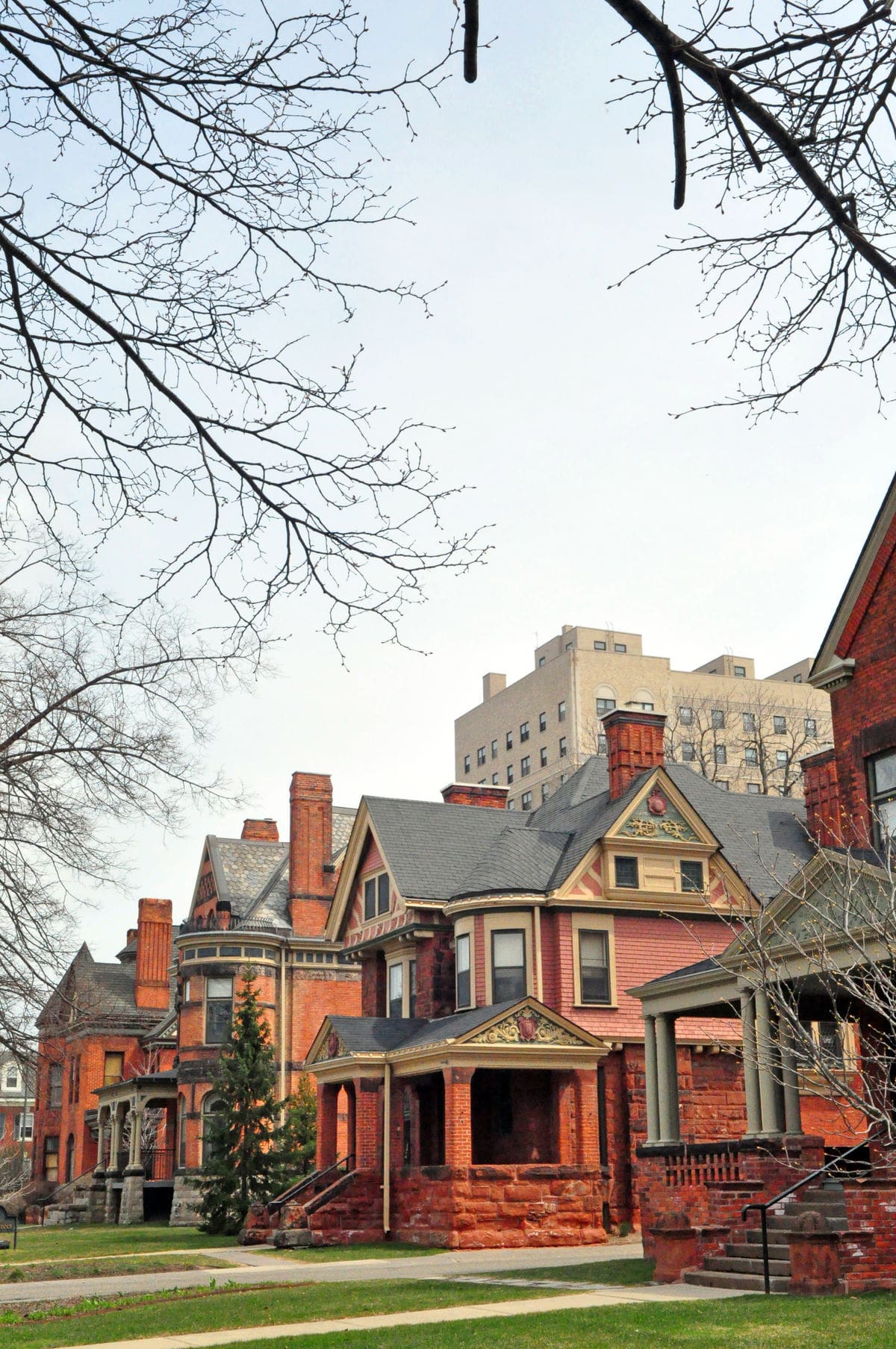 photo of the exterior of some historic red brick houses in midtown Detroit.