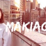 Image of a woman on top of a parking garage, looking out on to a large city. The woman has her eyes closed and is making a kissy face. In the center is large white marker-like text that says "Il Makiage"