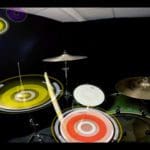 Photo of a drum set in a black room. There are yellow and red circles on top of the parts of the drum that are in motion, as a drumstick bounces around.