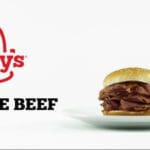 Advertisement showing a roast beef burger on a white plate on a white background. To the left is a red Arby's logo, and below is black bold text that reads "Love The Beef".