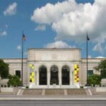 Wide shot photo of the front entrance of the Detroit Institute of Arts on a sunny day.