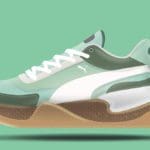 Digital rendering of a white, tan, brown and green sneaker on a green background.