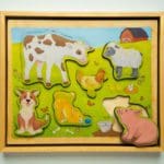 Photo of a toddler's animal puzzle depicting various farm animals.