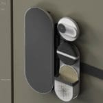 Close up shot of a futuristic concept doorbell. The product includes a camera, panel, speaker, and button.