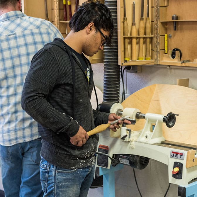 A man working on a project in a woodworking studio