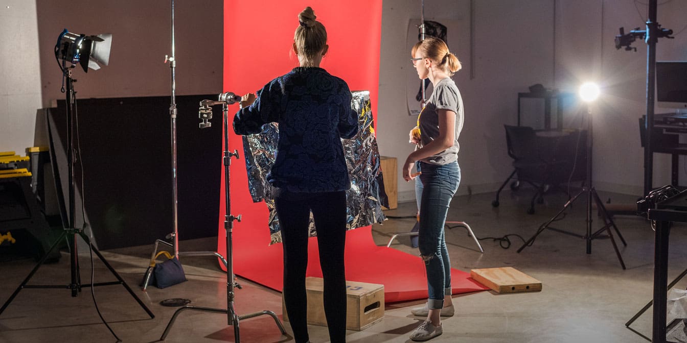 Photo of two women in a photography studio working on a photoshoot