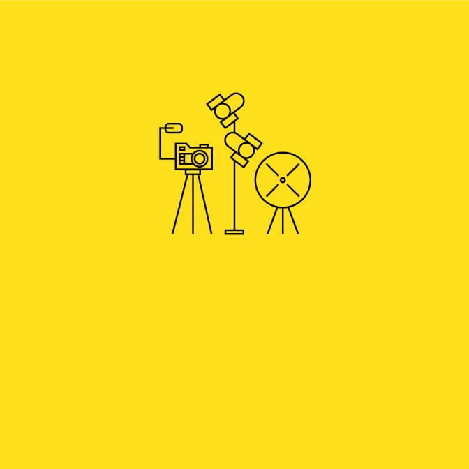 Three black icons of a camera tripod, stage lights, and softbox on a yellow background