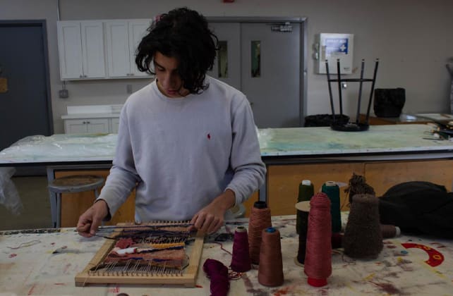 a student working on a textile project