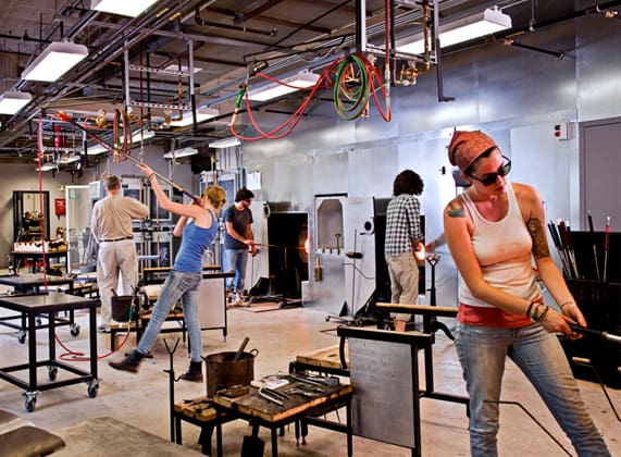 an inside look at a crafts studio showing students working