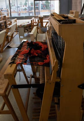 a worktable showing a textile being made