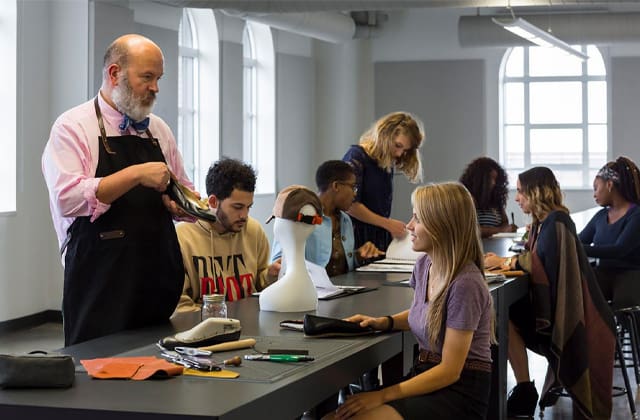 an instructor working along students in class