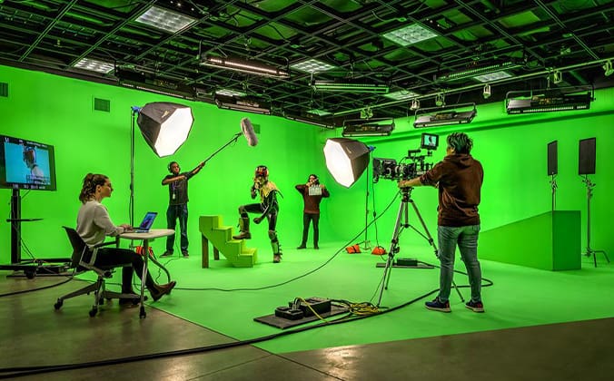 Photography Students doing a photoshoot in a green screen room