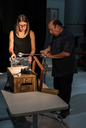 Photo of two people working on a photography project in a studio