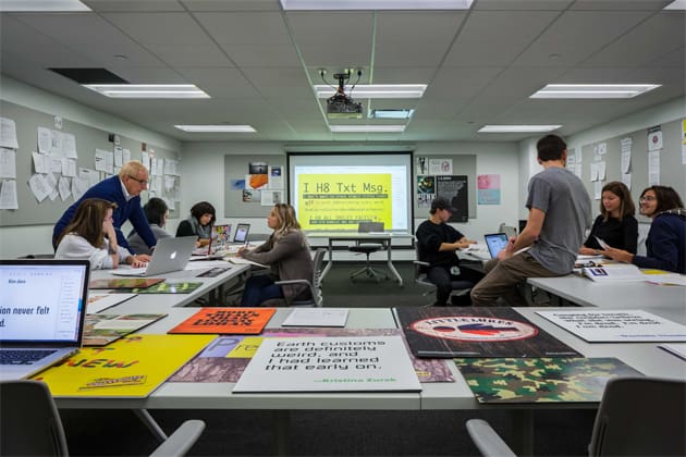 Students sitting in a classroom looking at a presentation onscreen