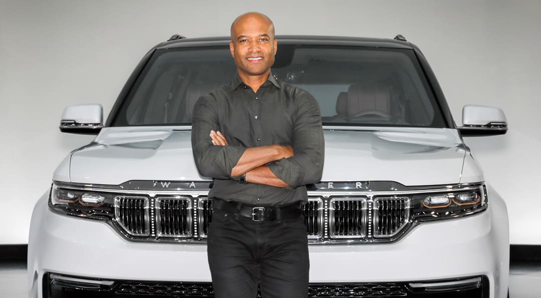 Photo of Ralph Gilles standing in front of a white SUV