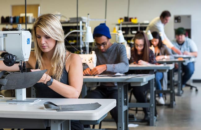 A photograph of students using a sewing machine