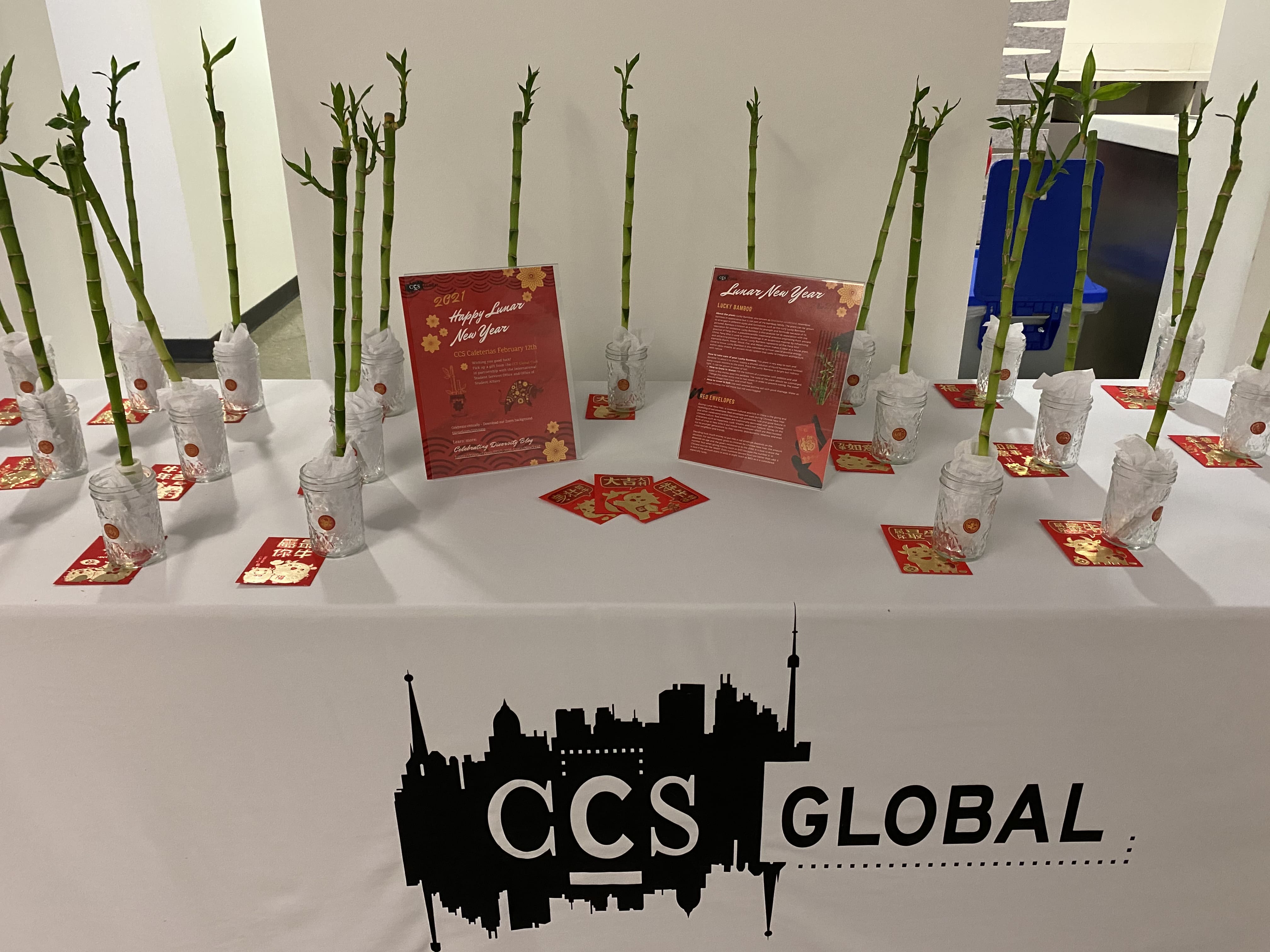 A table with bamboo, and red lunar new year flyers on it