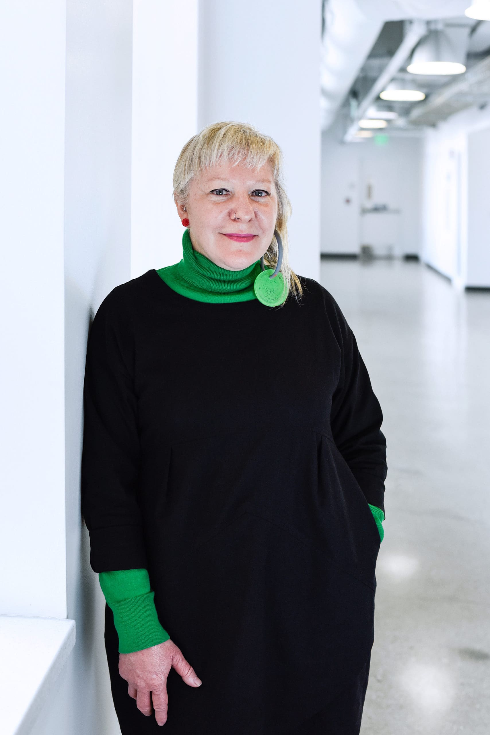 CCS professor and chair Melanie Mcclintock standing in a hallway inside of a school building