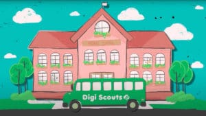An advertisement that depicts a digital drawing of a pink middle school building behind a green bus with the words "Digi Scouts" on the side in white. The building has many windows with potted plants handing underneath and a white flag on the roof. The sky is blue with a few white clouds, and the ground is grassy with four trees.