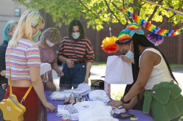 Students at a table during pride picnic