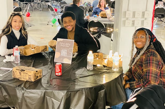 Students enjoying a boxed lunch at a DEI event