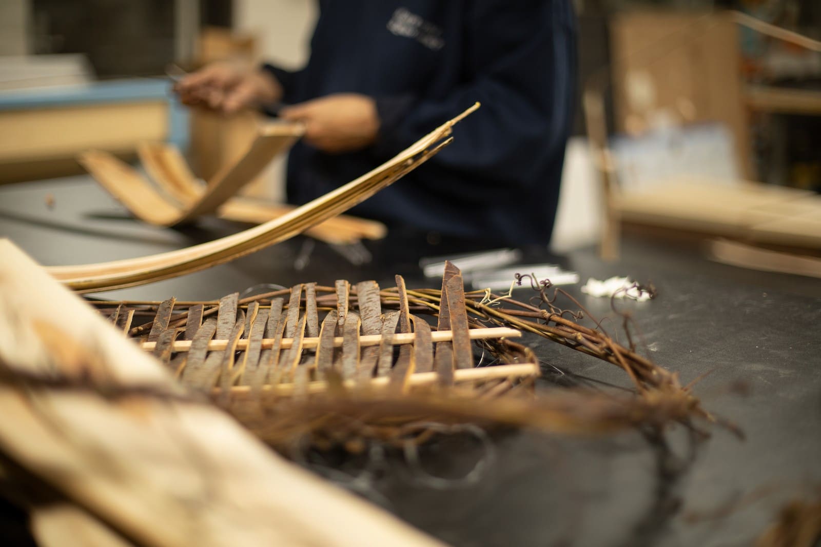 a weaving made of tree bark sitting on a worktable