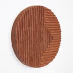 artwork of Ebitenyefa Baralaye.. Red clay ceramic plate with horizontal and vertical ridges