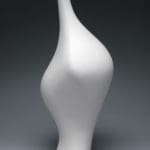 artwork of Ebitenyefa Baralaye. Organically shaped white ceramic sculpture on a grey background.