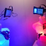 Two mannequin of human torsos connected to robotic sensors in an exhibition