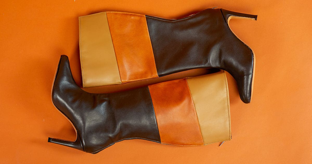 two leather boots on an orange background