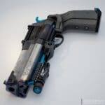3D render of a black and blue futuristic revolver with a steel engraved barrel. Done by EA Adjunct Faculty Adam Serhane.