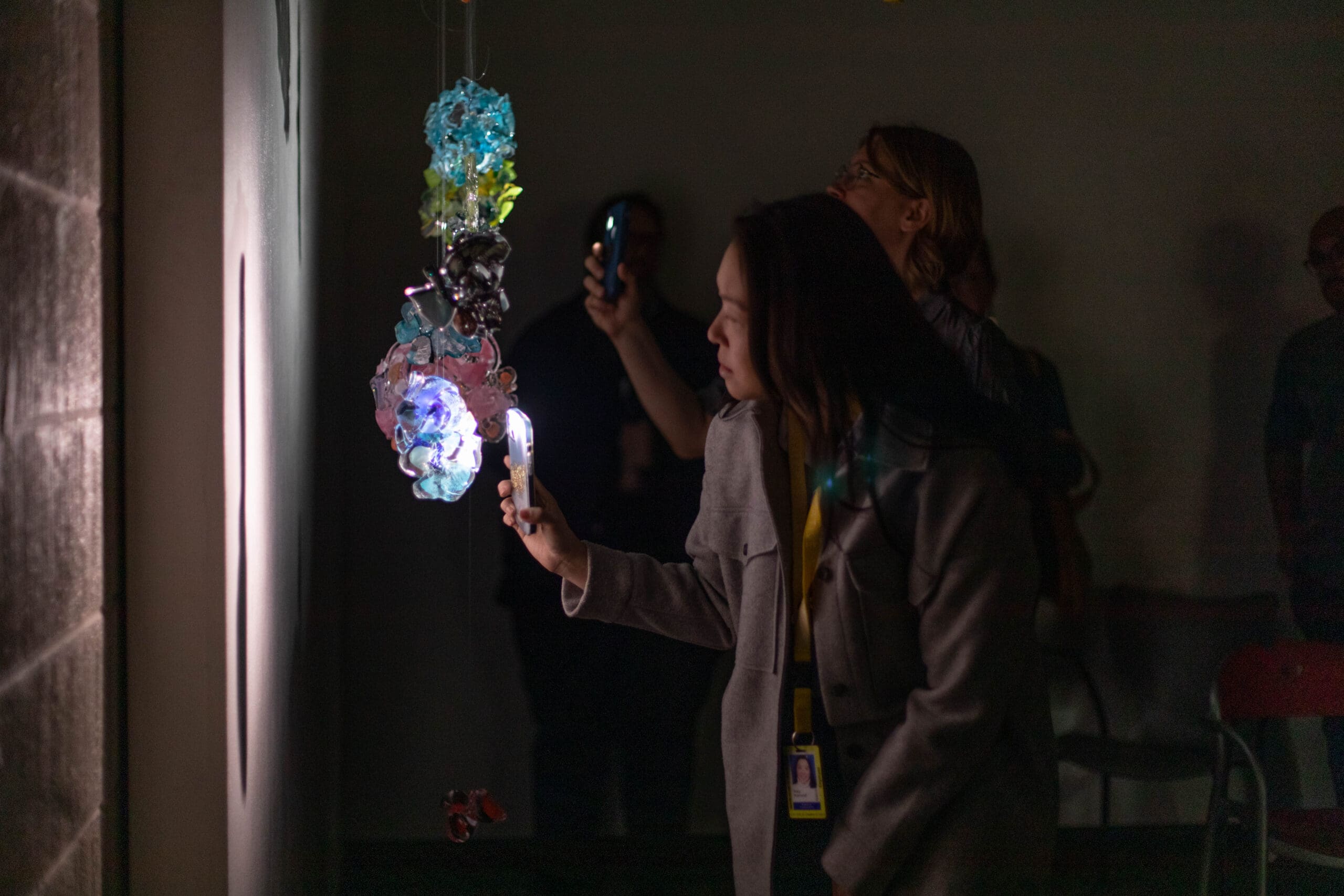 A woman looking at a glass sculpture in the Henry Ford Museum