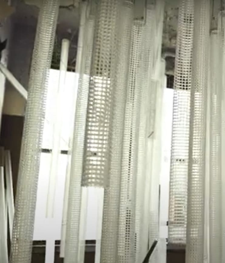 panels of white opaque materials hanging in front of a window