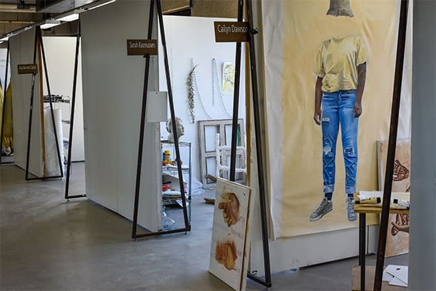 view of the semi-private studio space for seniors and juniors - one wall with a large scale canvas on it and another wall with a window installation