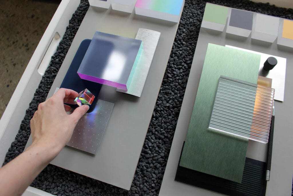 Someone holding a cube above a color and materials board