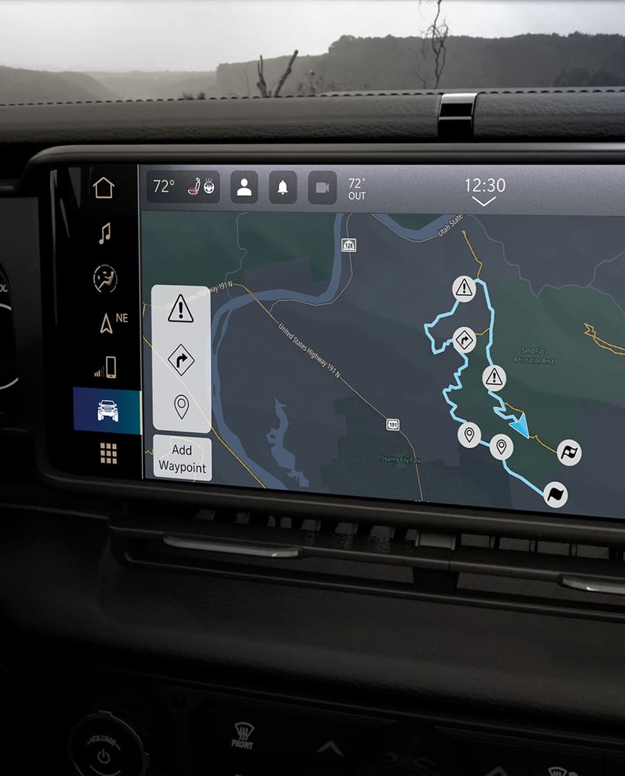 Photo of user interface screen in the front seat of a car. Screen displays a GPS