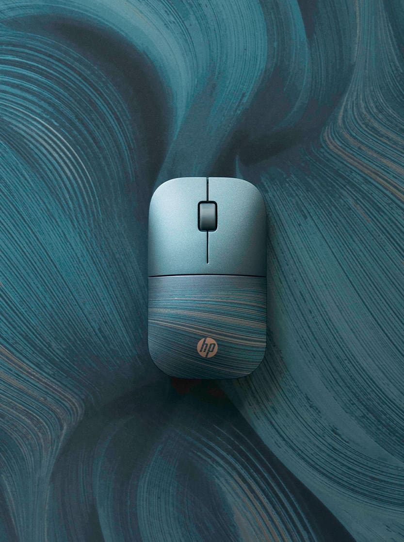 Photo of a blue computer mouse on a blue swirled background