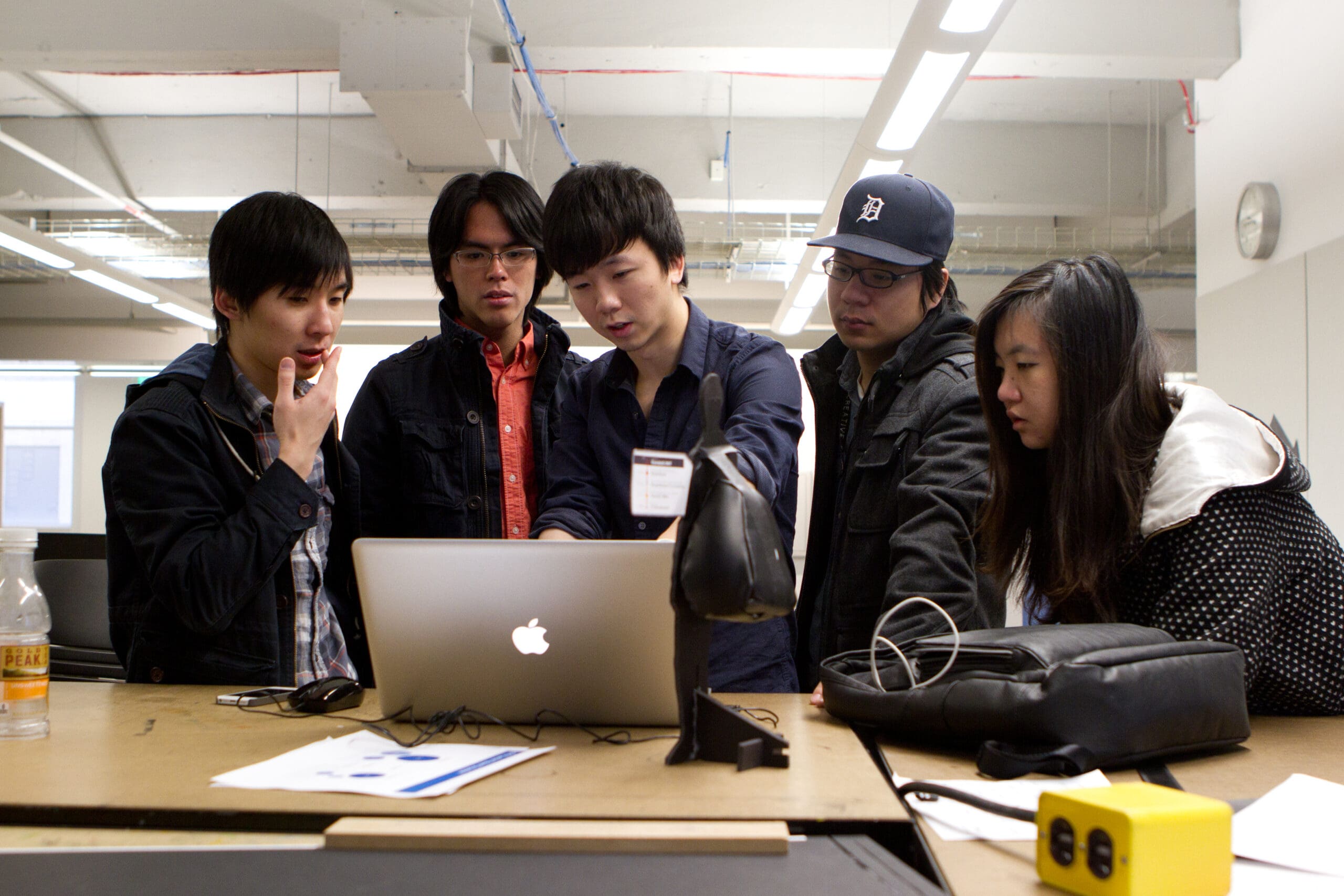 UX Students working around a computer