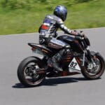 Man racing a motorcycle in full racing gear