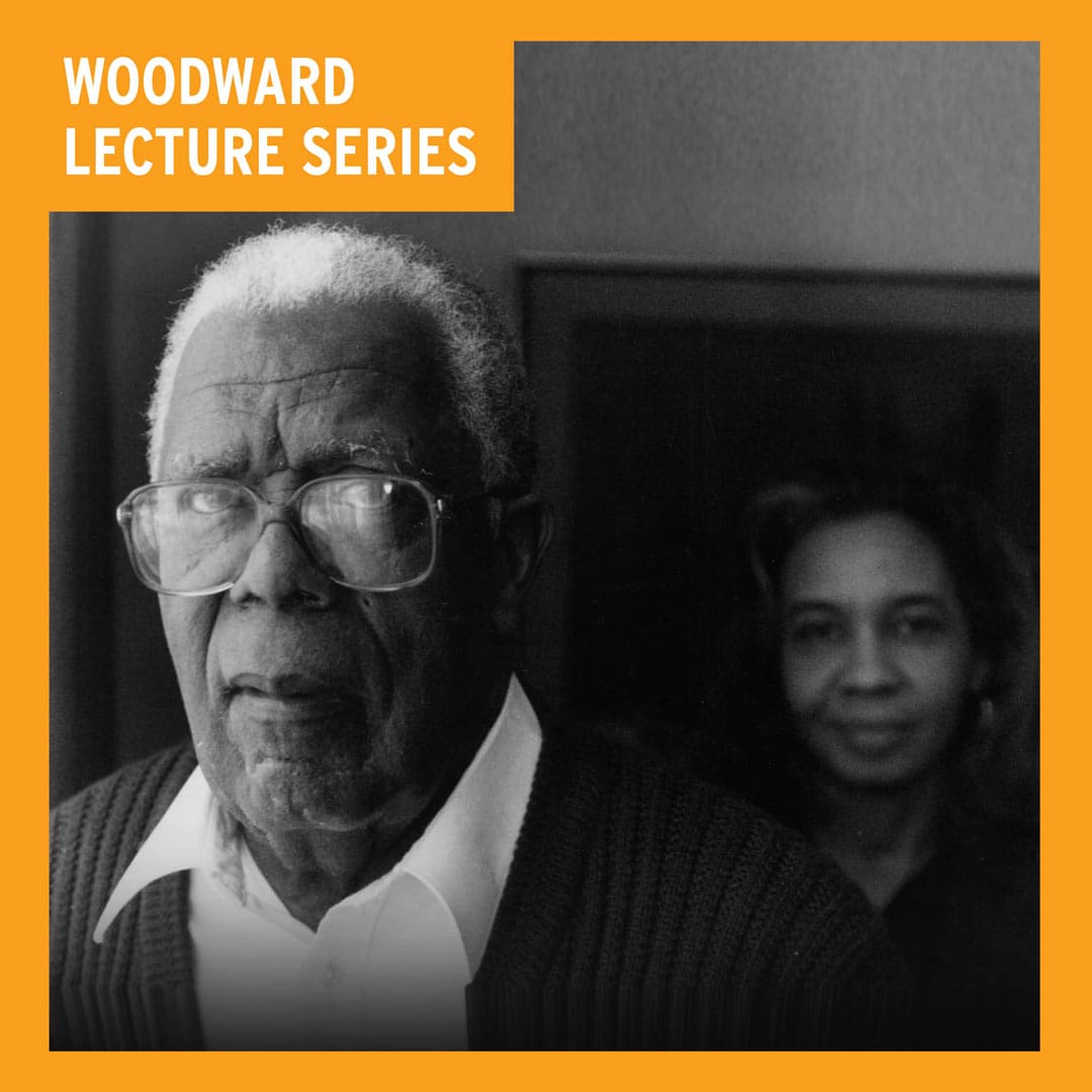 black and white photo of a man in glasses and white shirt with a woman looking on behind