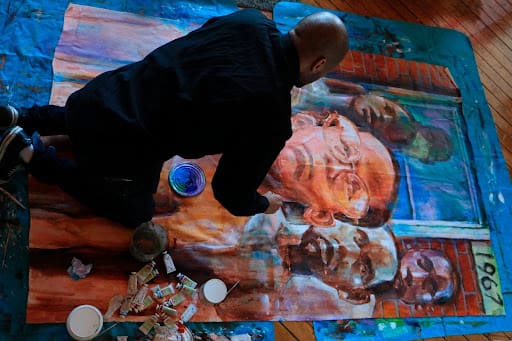 Stirling Toles working on a painting on the floor