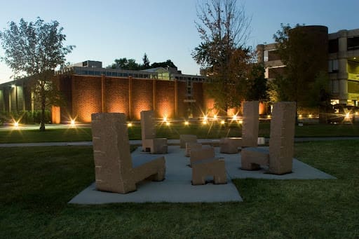 sculptural chairs in the CCS sculpture garden at dusk