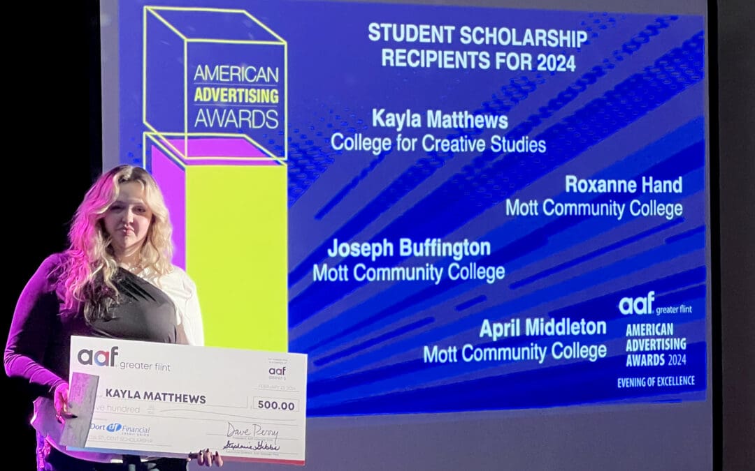 senior Kayla Matthews posing with her award for student scholarship recipient for the 2024 ADDY's